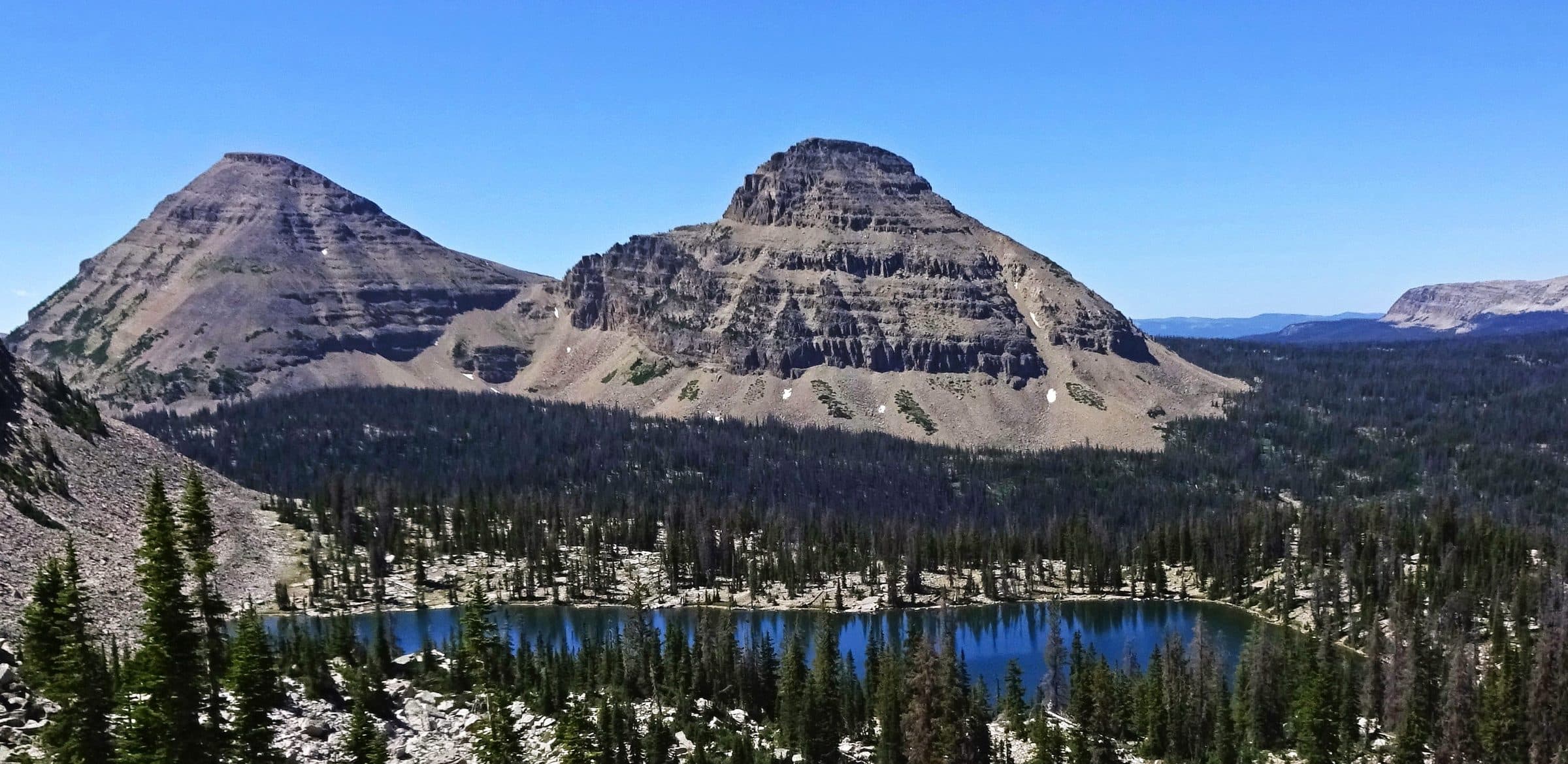 Reids Peak and Bald Mountain above a blue alpine lake in the Uinta Mountains